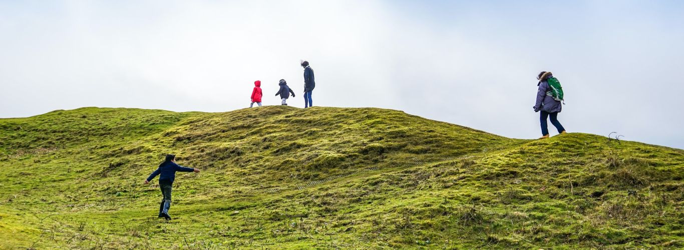 Family hiking on hill